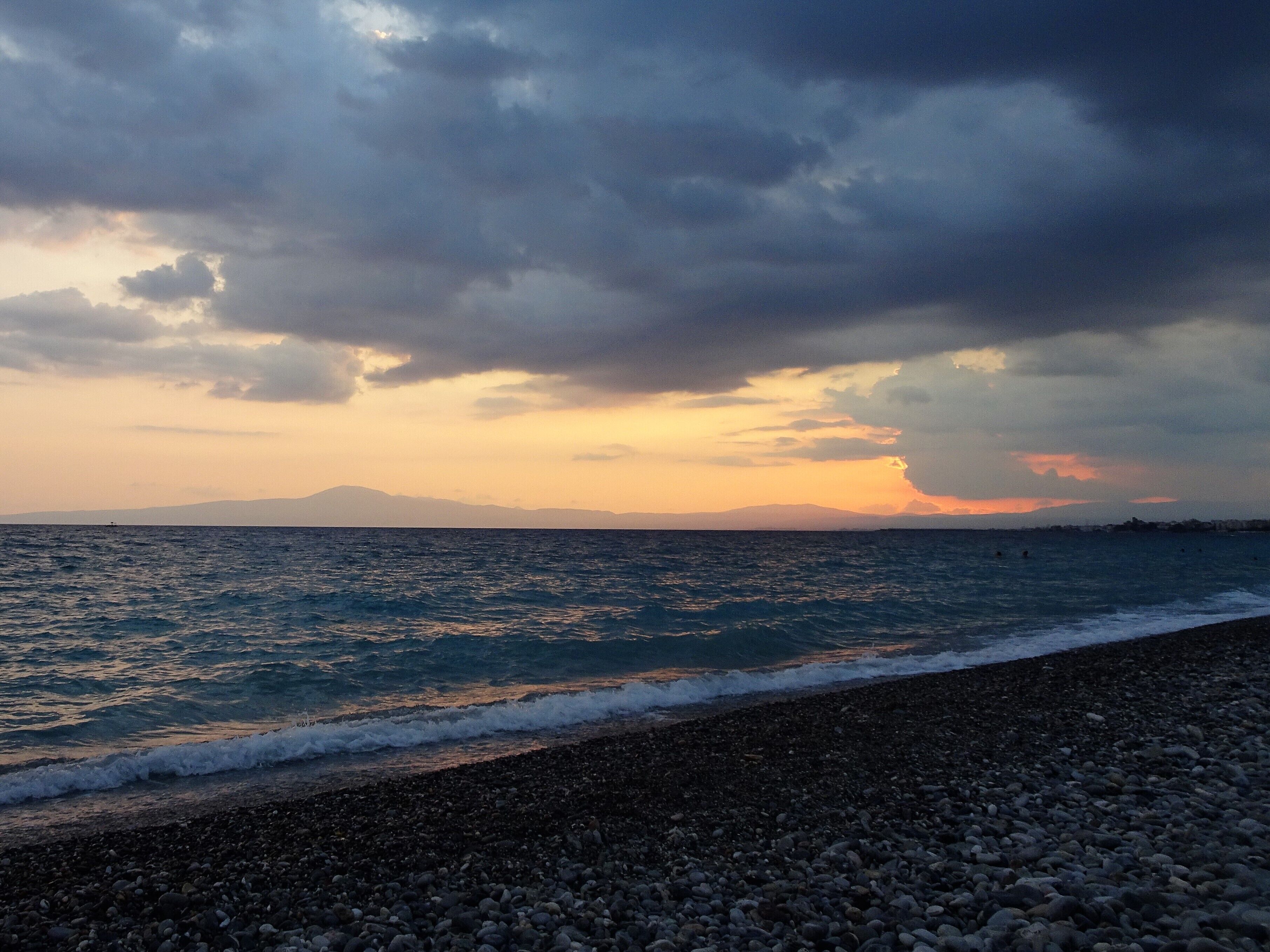 Bay of Kalamata: the setting sun makes way for dark thunderclouds.