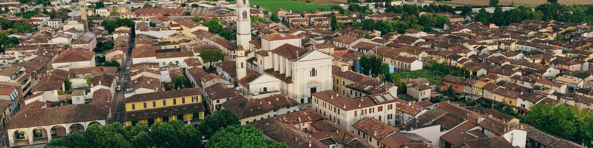 Breathtaking aerial views of the historic Italian town of Pontevico in the province of Brescia Italy showcasing its charming architecture and scenic landscape under a dramatic sky