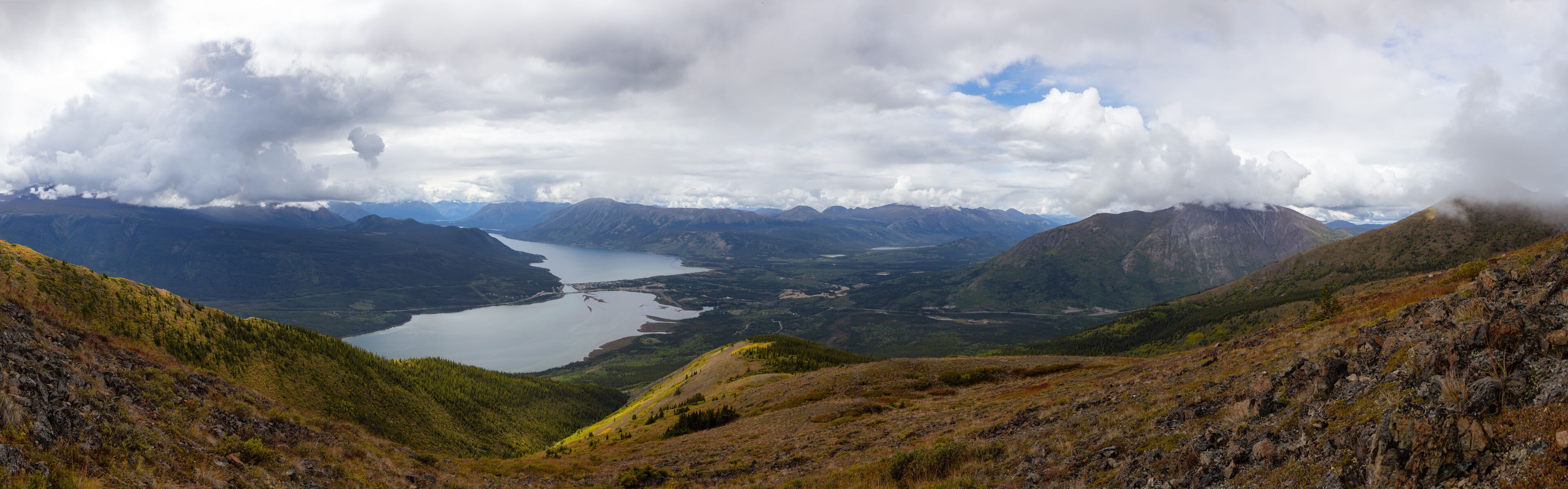 Beautiful Panoramic View of a small Touristic Town, Carcross, surounded by Canadian Mountain Landscape. Located near Whitehorse, Yukon, Canada.