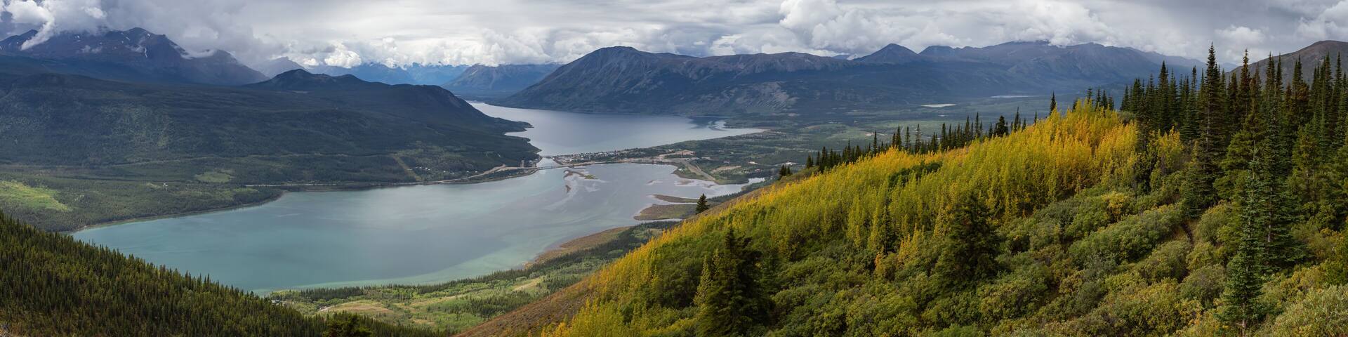 Beautiful Panoramic View of a small Touristic Town, Carcross, surounded by Canadian Mountain Landscape. Located near Whitehorse, Yukon, Canada.