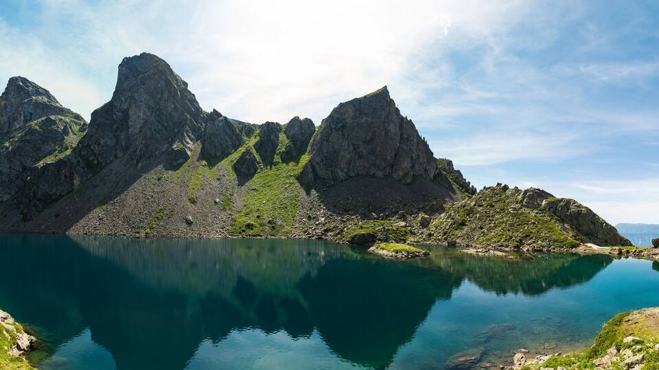 A mountain lake with rocky peaks and clear water.