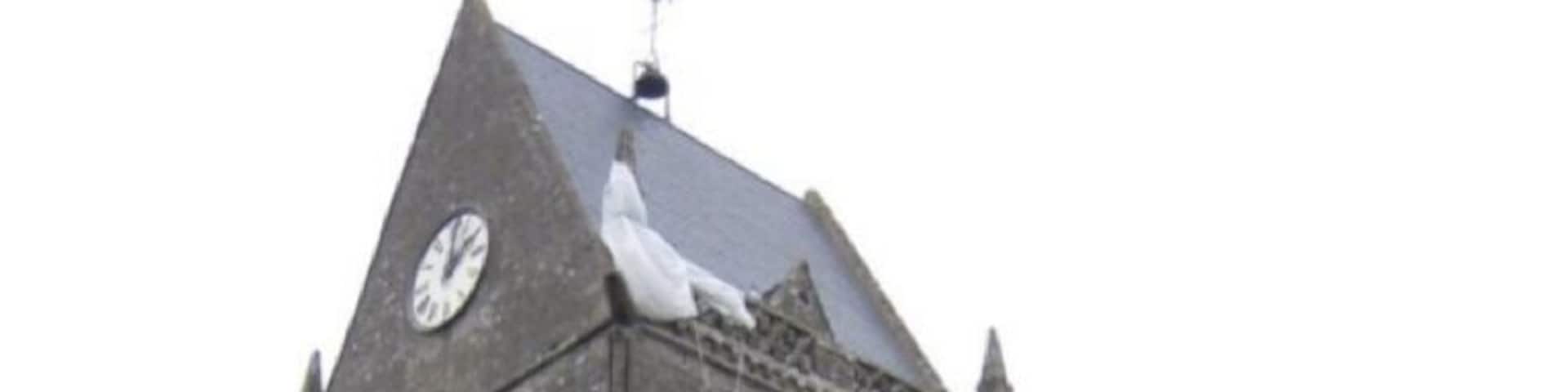 On D-Day, John M.Steele, one of the mortar platoon of the 505 PIR of the US 82nd Airborne had his chute snag on the church tower as he descended. Here he hung during the battle, watching helplessly as his colleagues fought below. This scene was famously reenacted in the film "The Longest Day", and a manequin now hangs from the church in Ste Mere Eglise depicting the event (do you see him?)