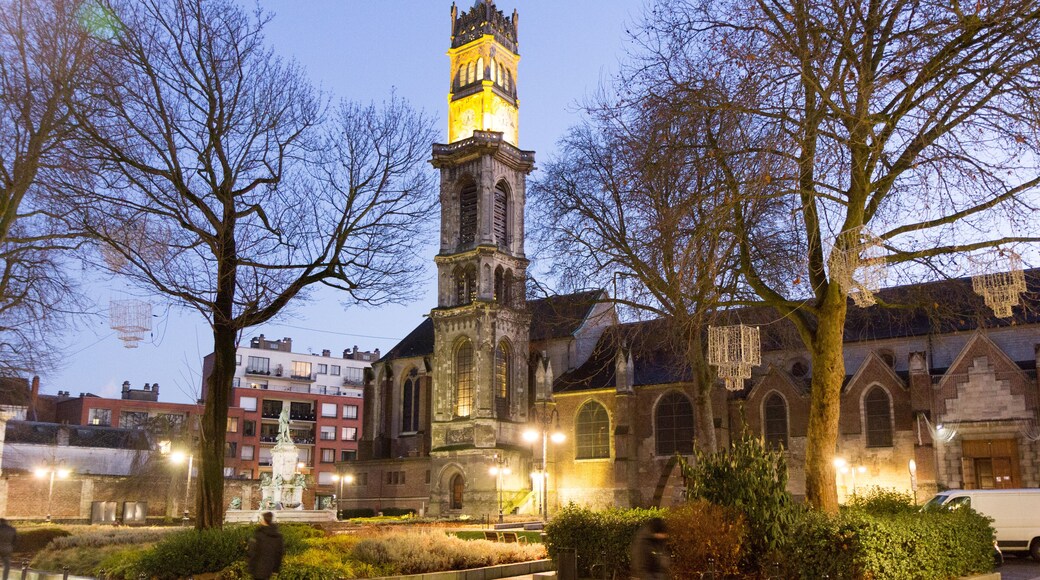 Valenciennes, France, 2017-01-05. The steeple with a bell and a clock of Saint Gery (Gaugericus) church at dusk.