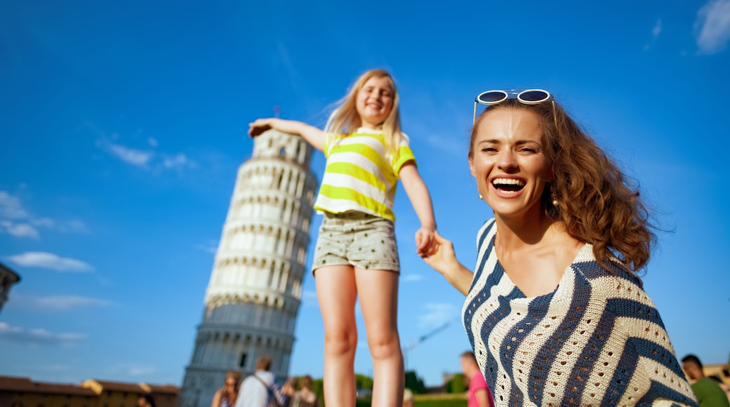 smiling modern mother and daughter posing for tourist picture