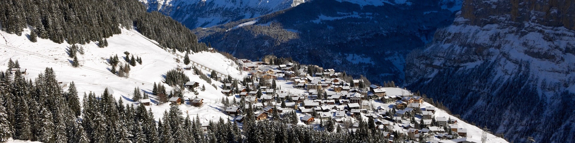 Muerren featuring mountains, a small town or village and snow