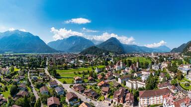 Aerial view over the city of Interlaken in Switzerland. Beautiful view of Interlaken town, Eiger, Monch and Jungfrau mountains and of Lake Thun and Brienz. Interlaken, Bernese Oberland, Switzerland.