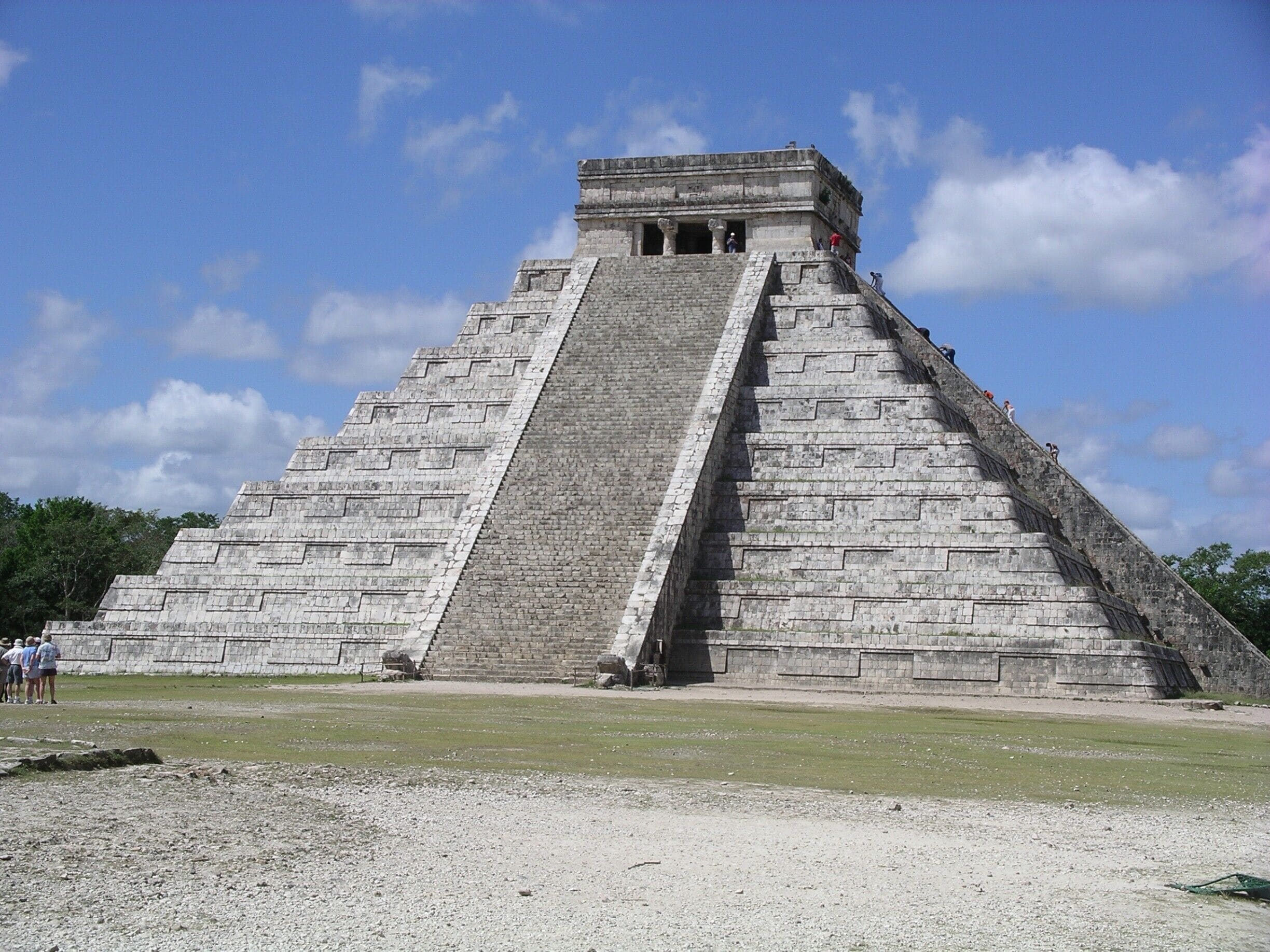 If you go to only one ruin in the Cancun area, I would highly recommend Chichen Itza. It will be an all day excursion but well worth it.  Go as early as possible with a reputable and knowledgeable tour company (we used Thomas Moore) and in a small group.  We were there in the month of June and arrived mid morning. As we were leaving,  the place was starting to get packed with all the larger tour buses and was getting very warm.  I have also visited Tulum in June but was disappointed after have already visited Chichen Itza.  
I believe that you can no longer climb the well known Kukulkan Pyramid.