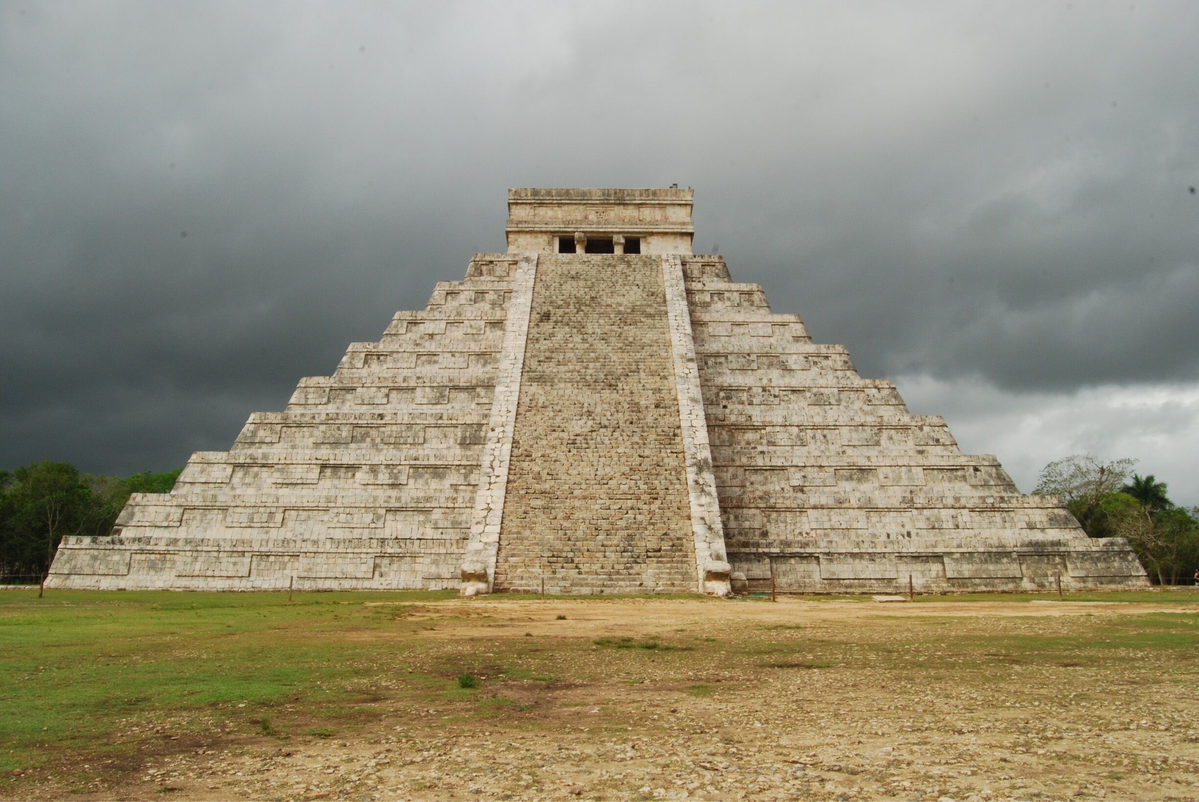 Chichen Itza in Mexico... Mayan ruins are pretty amazing to see, especially with an ominous storm cloud overhead!