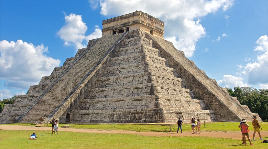 Chichen Itza featuring heritage architecture as well as a small group of people