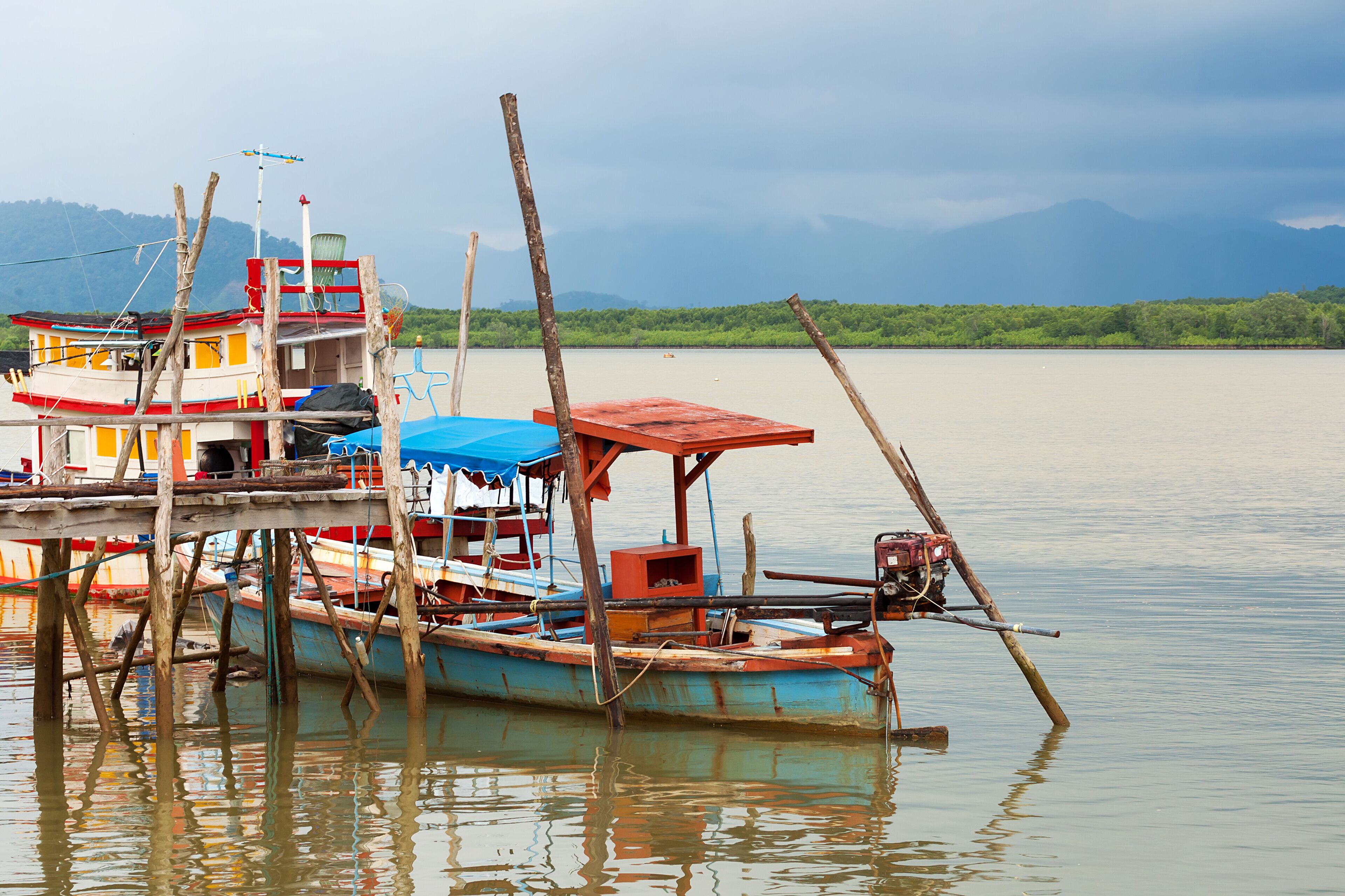 Thai long tail boats in the harbour, Thailand