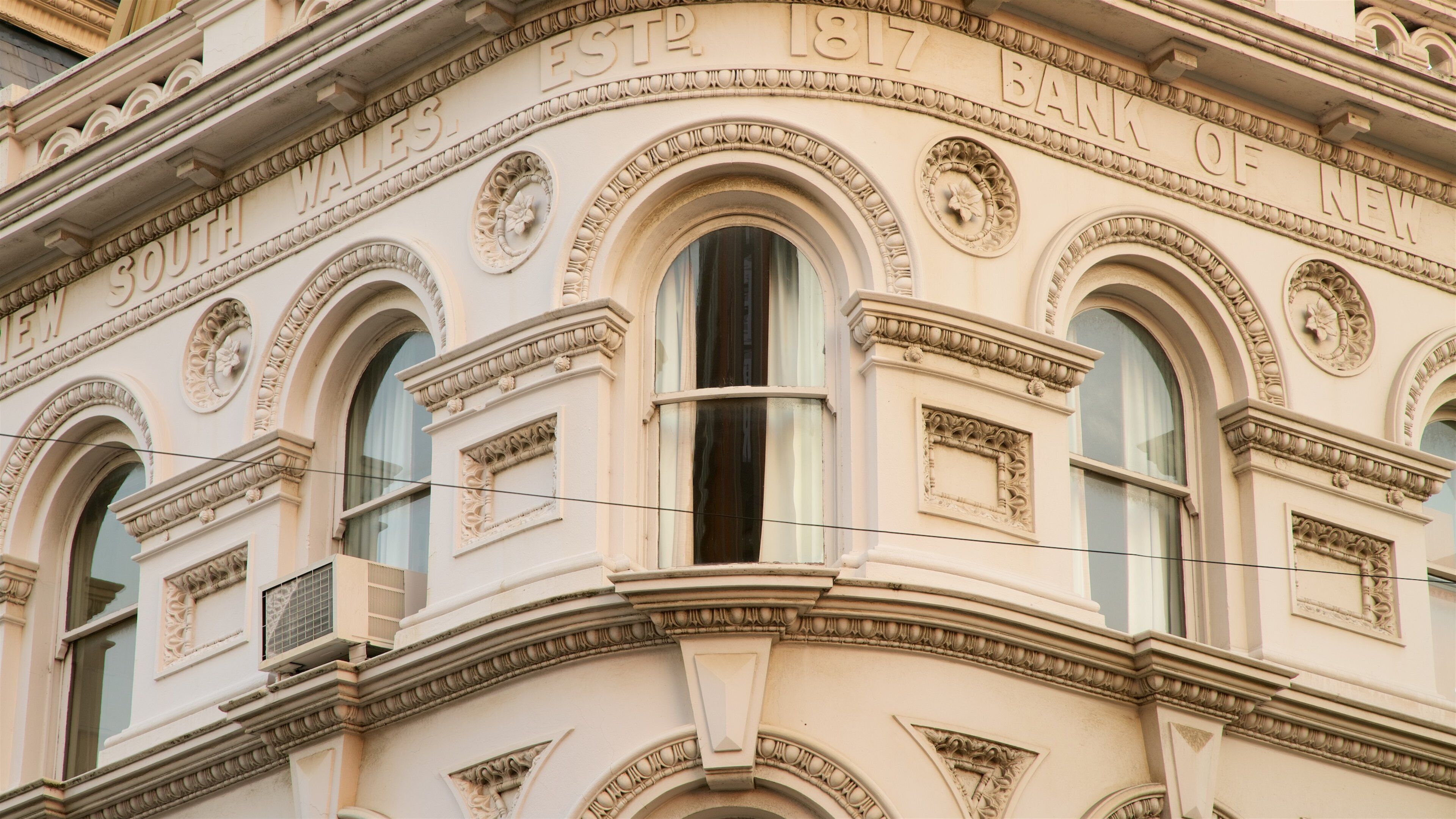A building facade with ornate carvings and the inscription "South Wales Bank 1817".