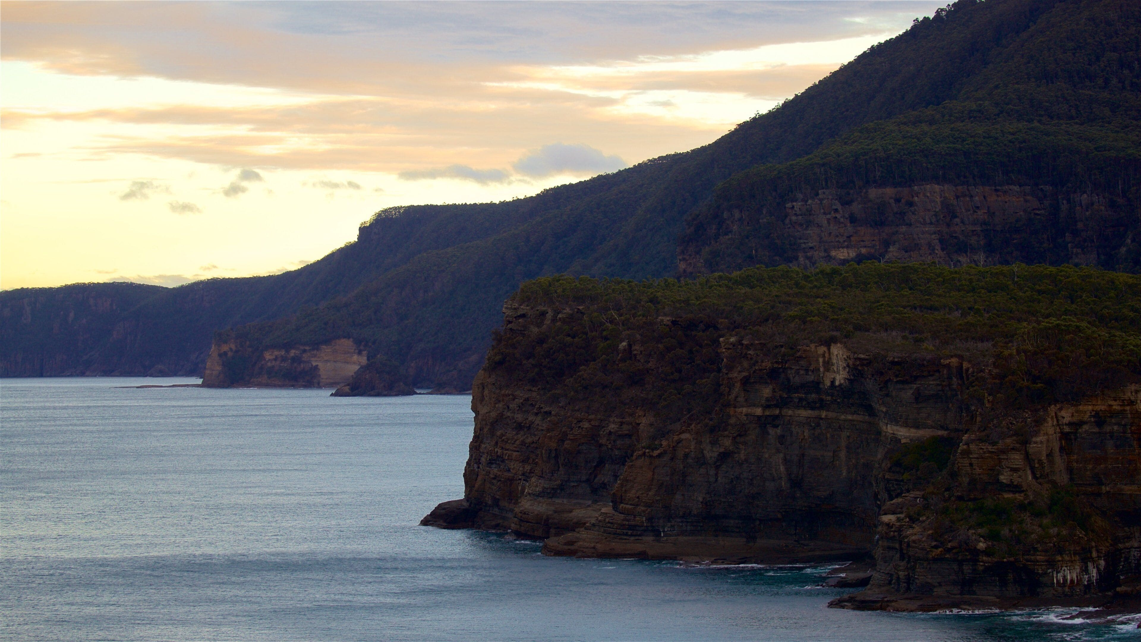 Tasman Peninsula showing a sunset, landscape views and rugged coastline