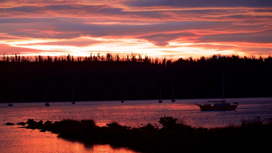 Tasman Peninsula which includes general coastal views and a sunset