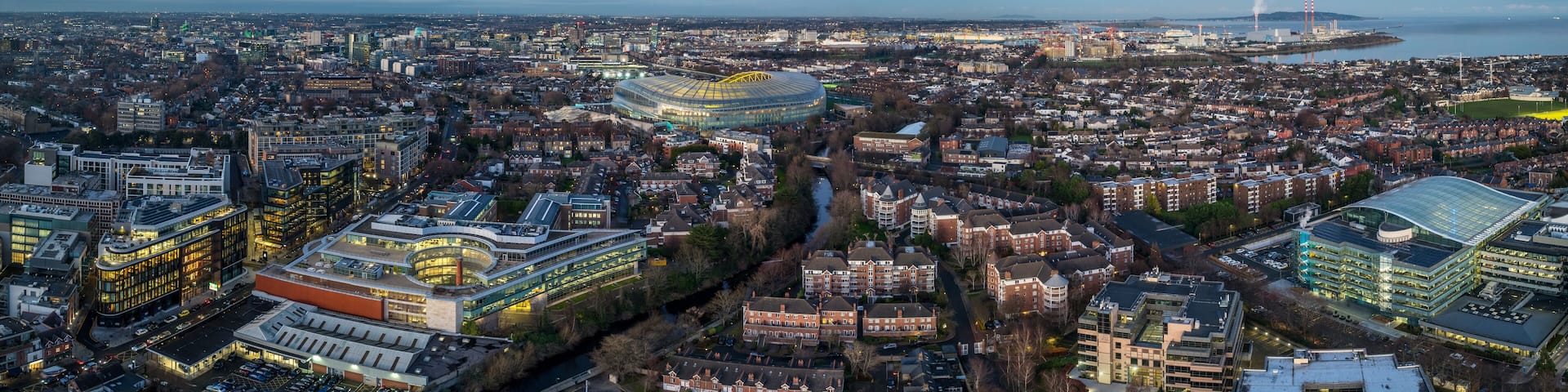A cityscape with a prominent stadium, residential areas, and industrial buildings.