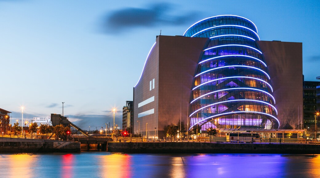 The Convention Centre Dublin featuring a sunset, a river or creek and a city