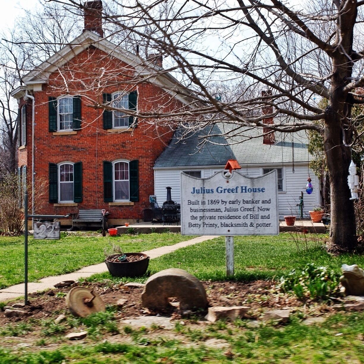 A brick house with a sign reading "Julius Greef House."