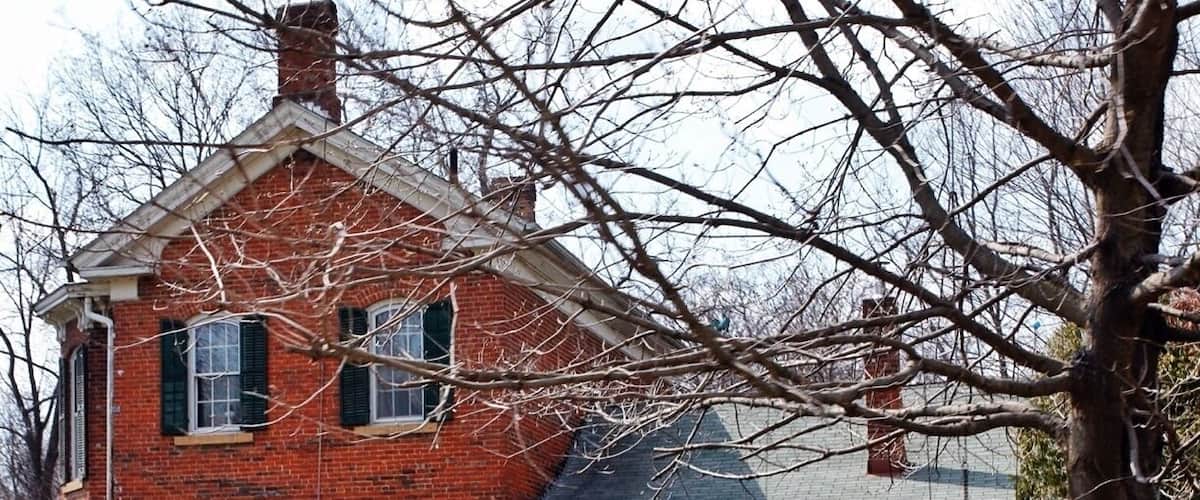 A brick house with a sign reading "Julius Greef House."
