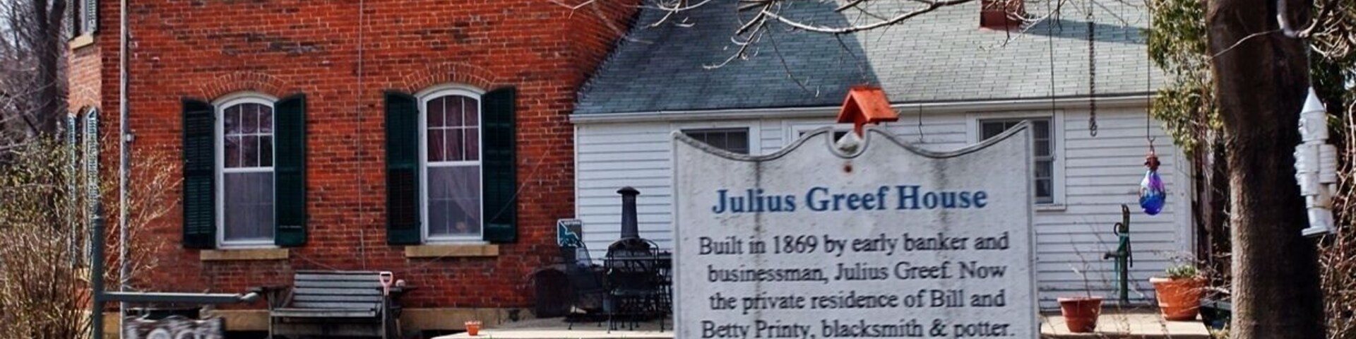 A brick house with a sign reading "Julius Greef House."
