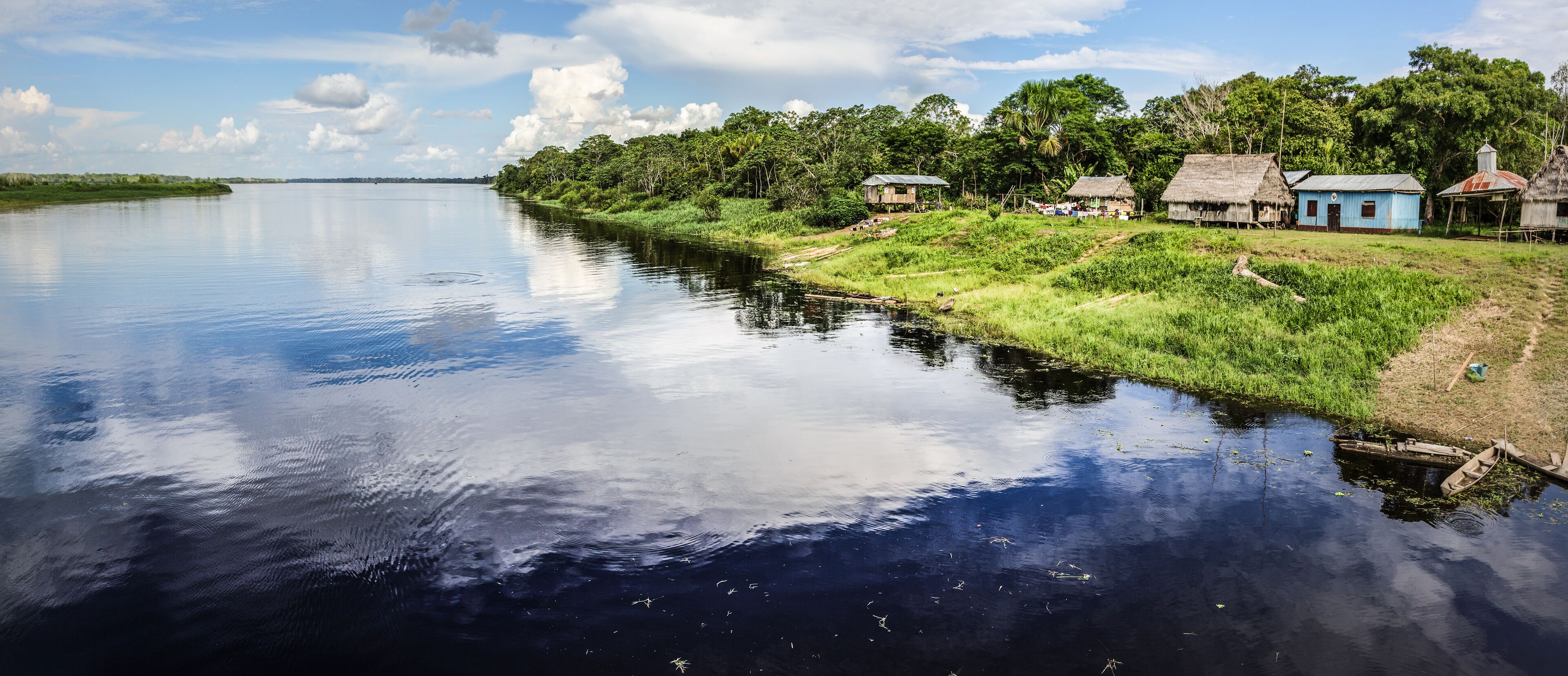 Reflection of the cloud on a black water tributary river of the Amazon.