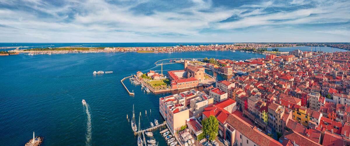 A coastal city with a marina, historic buildings, and a river.
