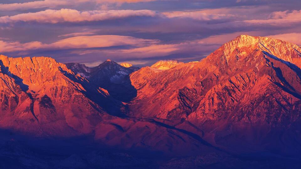A mountain range with sharp peaks and a valley.
