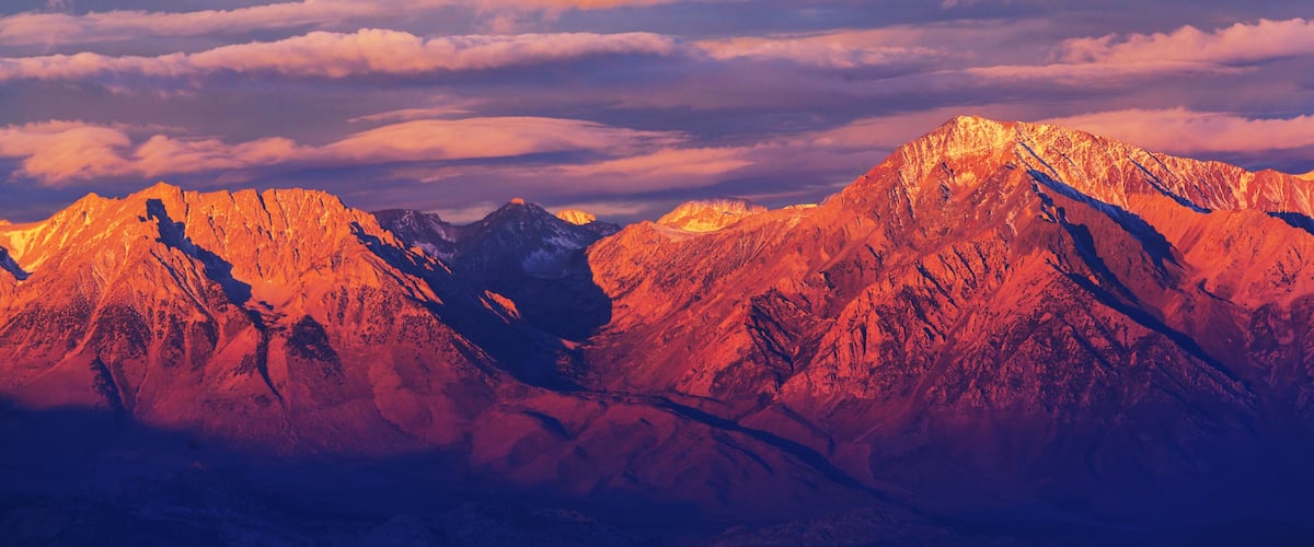 A mountain range with sharp peaks and a valley.