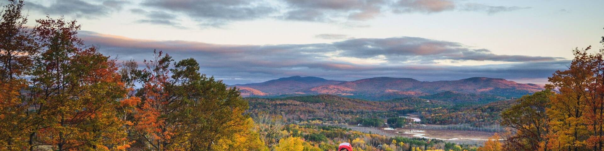 Man trail running in mountains during foliage season
