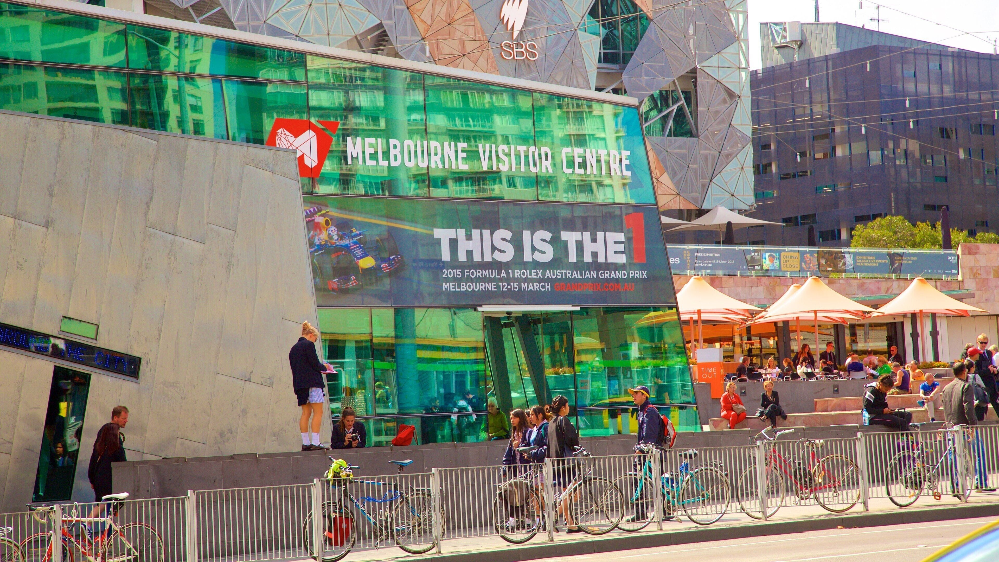Federation Square which includes a square or plaza as well as a large group of people
