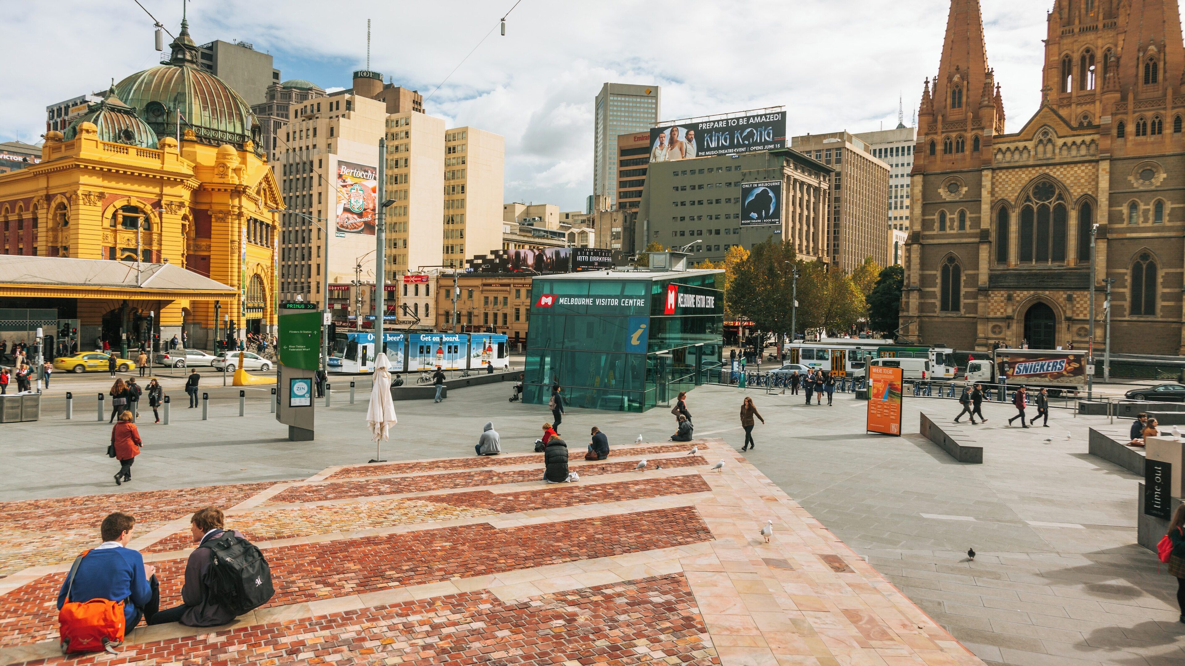 Vibrant gathering at Fed Square near Yarra Riverfront in Melbourne, showcasing iconic architecture and lively urban atmosphere