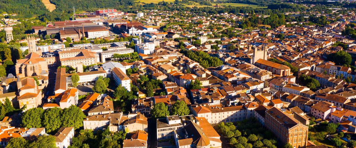 A densely packed town with historic buildings and a prominent church.