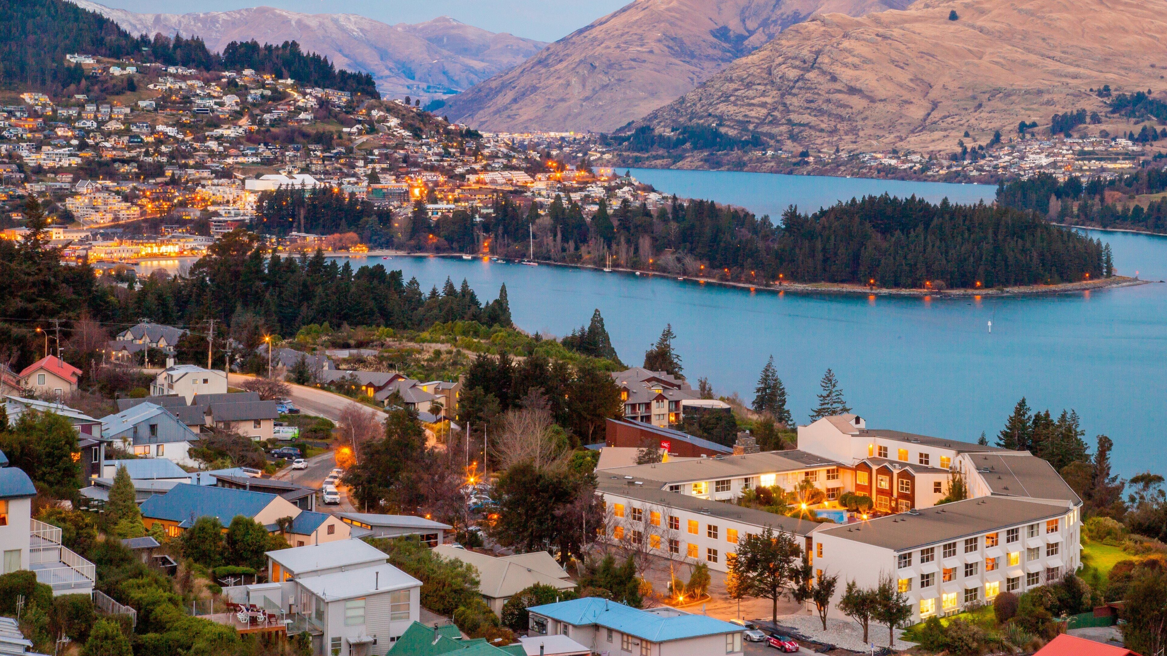 Queenstown featuring a river or creek, a sunset and a small town or village