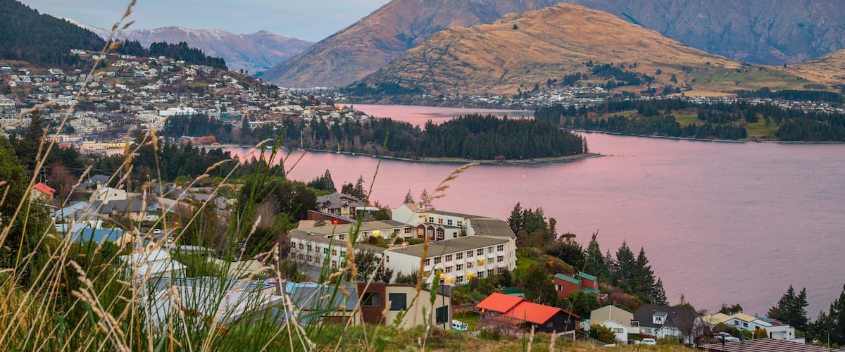 Queenstown featuring a sunset, a river or creek and mountains