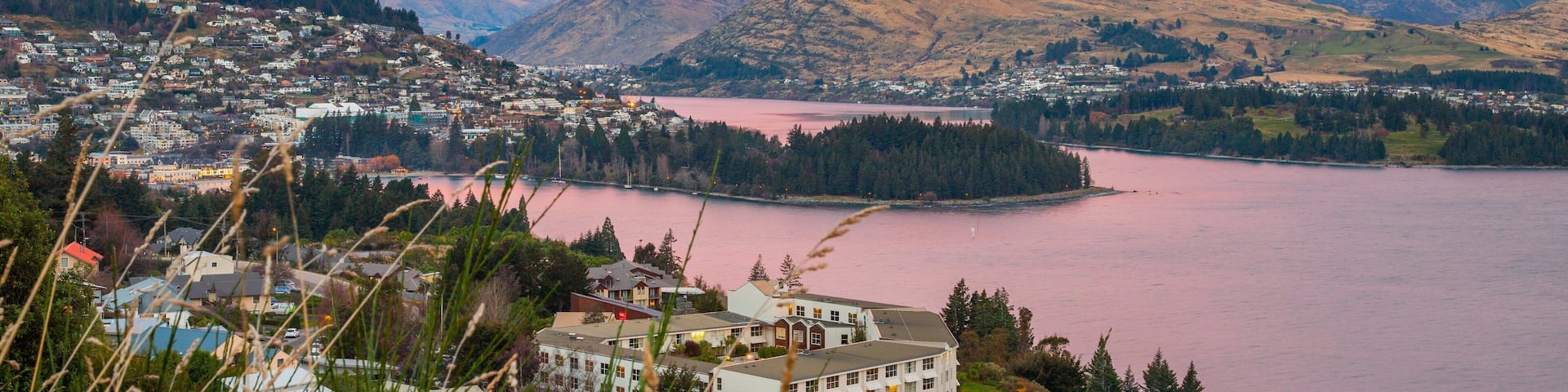 Queenstown featuring a sunset, a river or creek and mountains