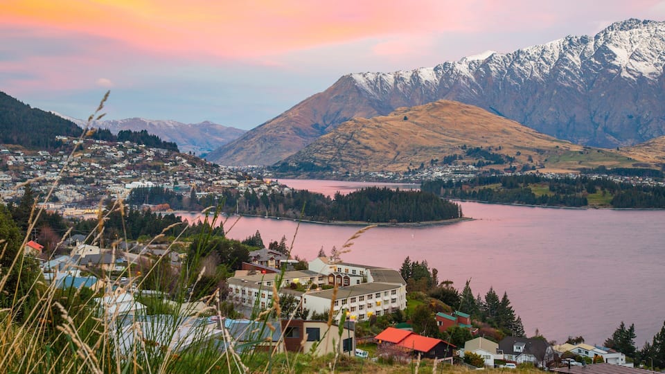 Queenstown featuring a sunset, a river or creek and mountains