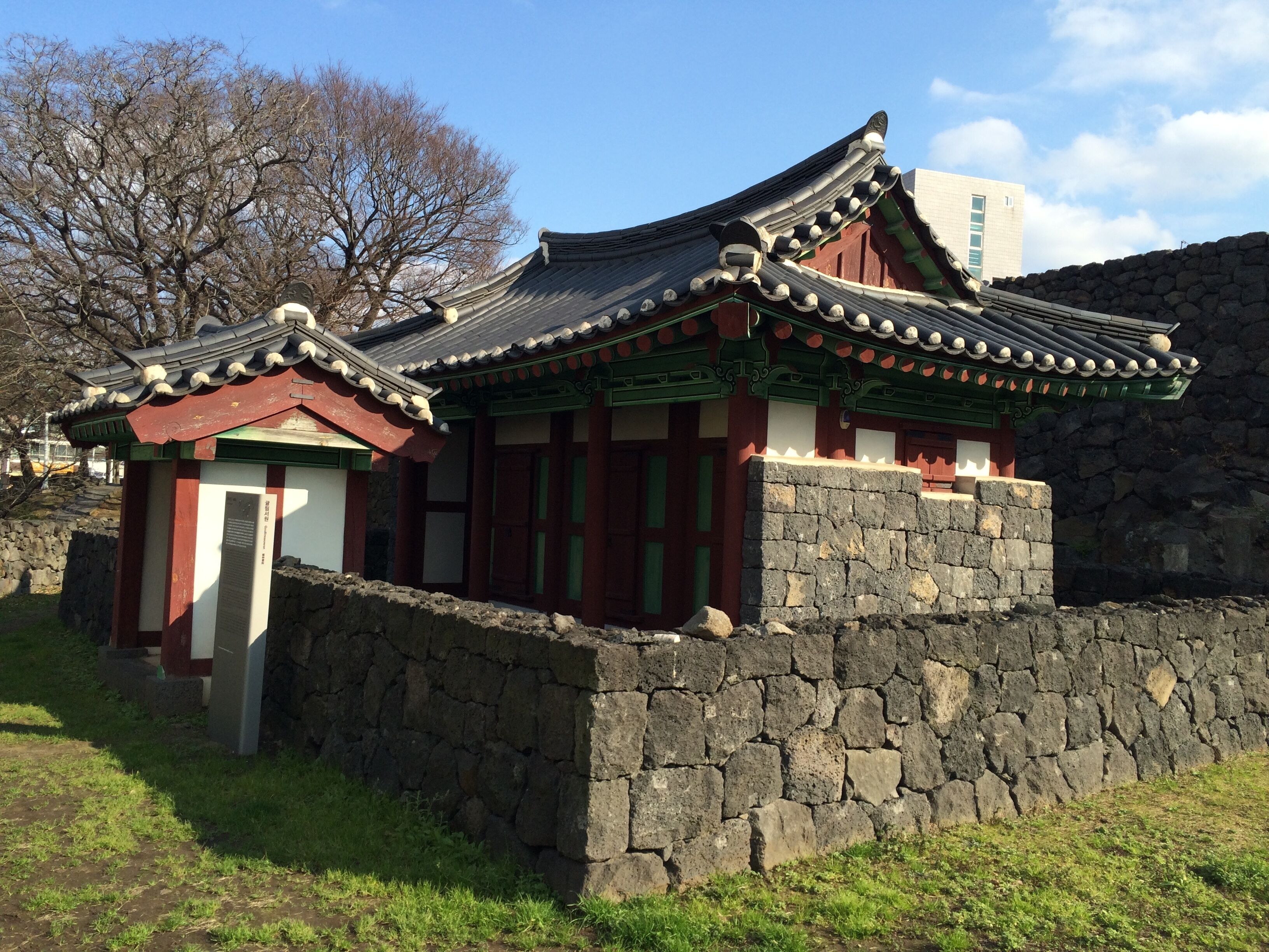 A traditional Korean building with a tiled roof and stone walls.