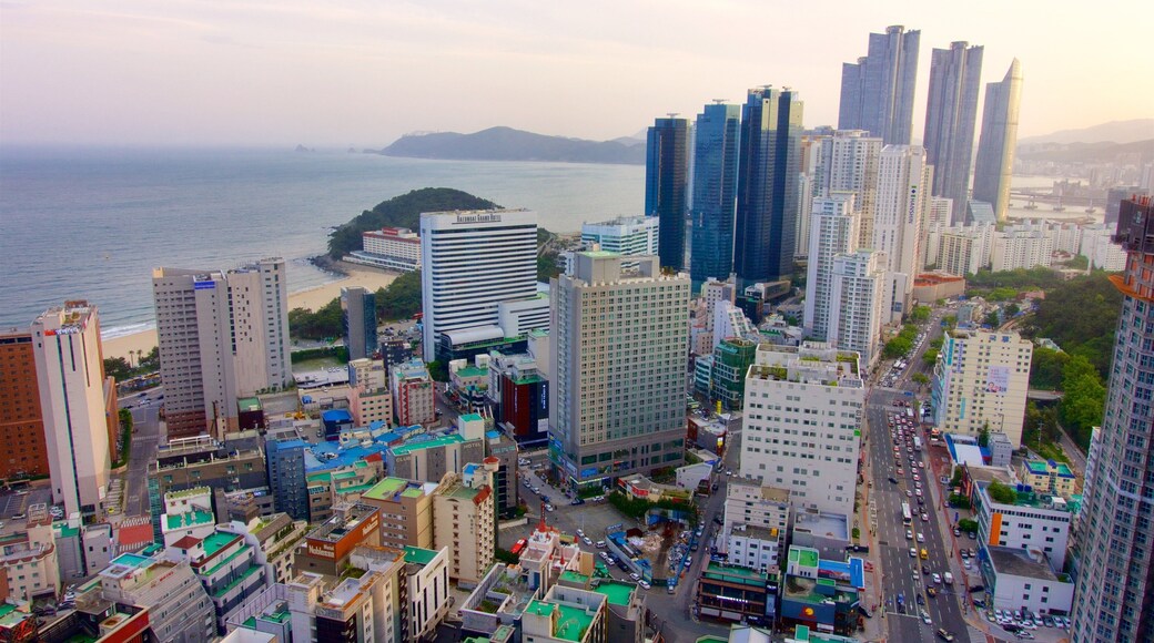 Haeundae which includes general coastal views, a sunset and a coastal town