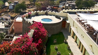 If you've got the ching, you might want to spring for the Devi Garh. This luxury hotel and former hilltop palace of Raghudev Singh II is ringed by the Aravali Hills and looks down over the dusty town of Delwara, which spreads like a worn, pastel carpet at the feet of its massive gates. The hot tub, alone was a thing of beauty, flanked by an abundance of bright, climbing flowers and a sweeping view of the mountains. • http://www.lebua.com/devi-garh • #Delwara #India #DeviGarh