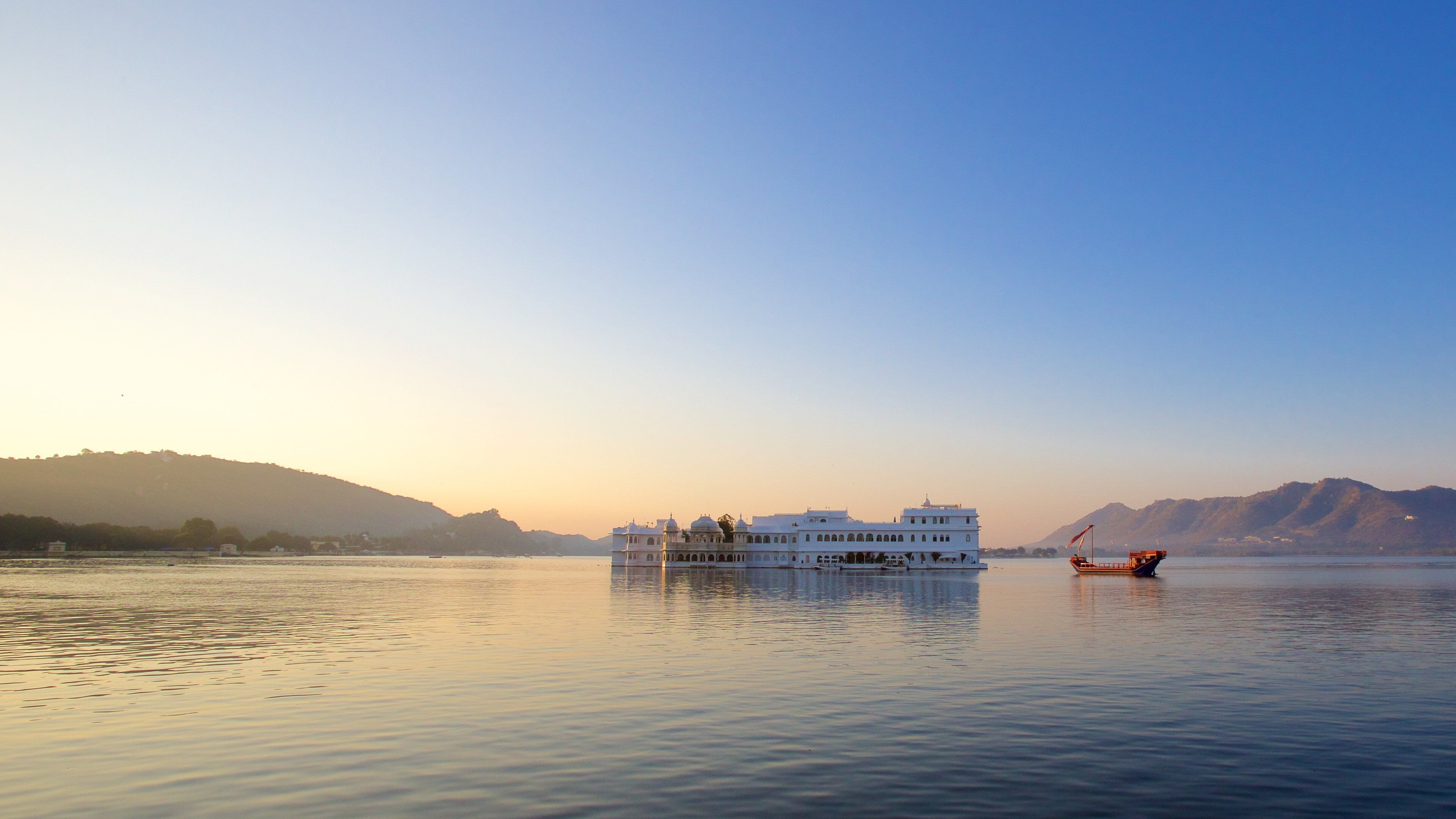 Udaipur District showing island images, a sunset and a lake or waterhole