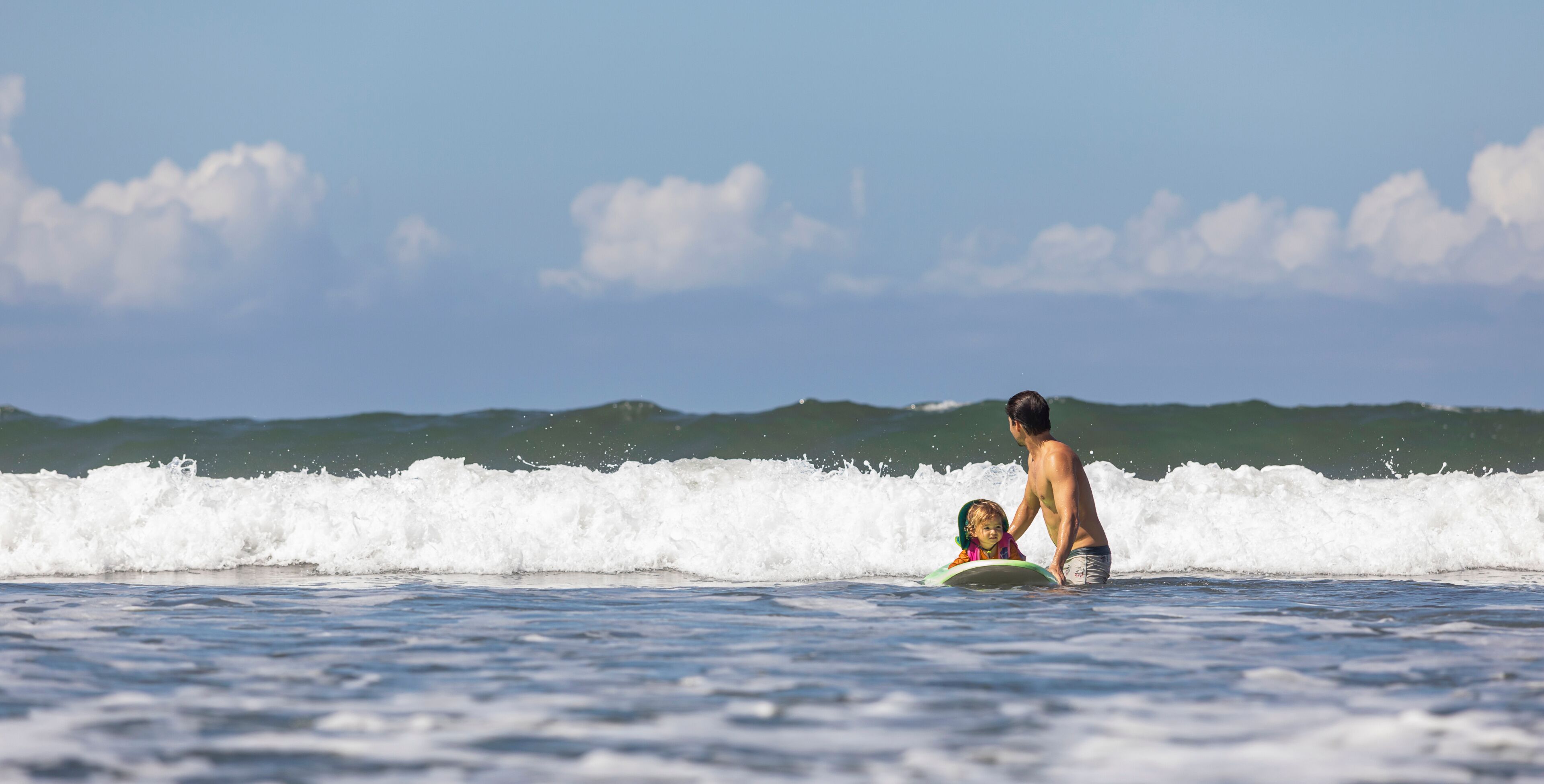 Hispanic Family Surfing Together 