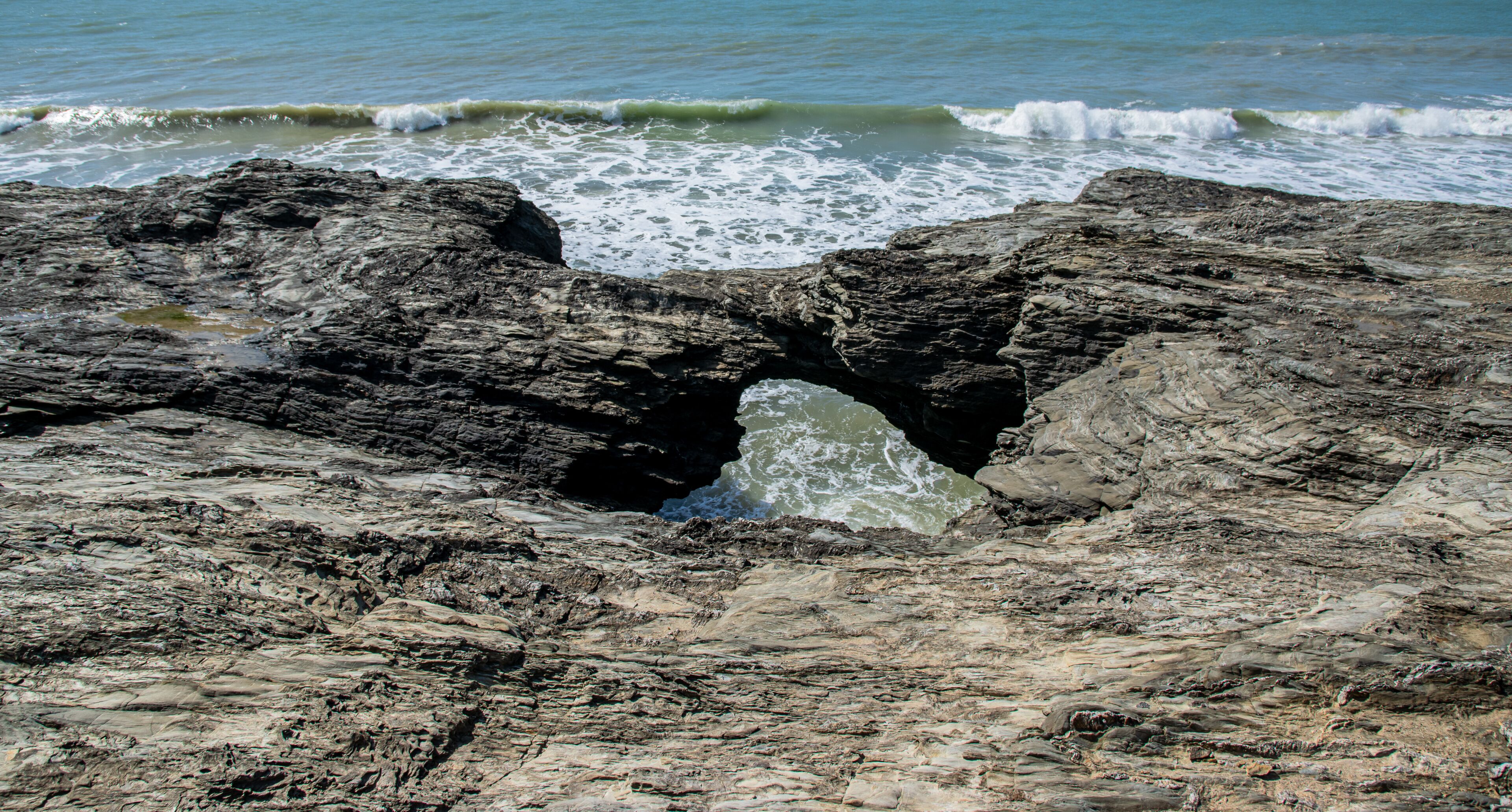 Vendée, France; March 28, 2021: Photo of the Trou du Diable seen from above, a sea cave on the Corniche de Rié, in the town of Saint-Hilaire-de-Riez. 