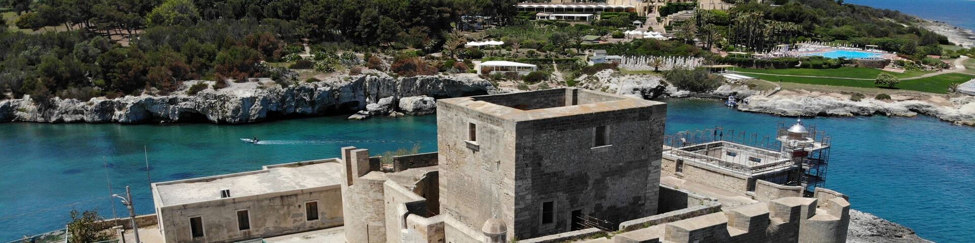 Brucoli castle fortress aerial view, panorama of the bay with blue sea and rocky coast around