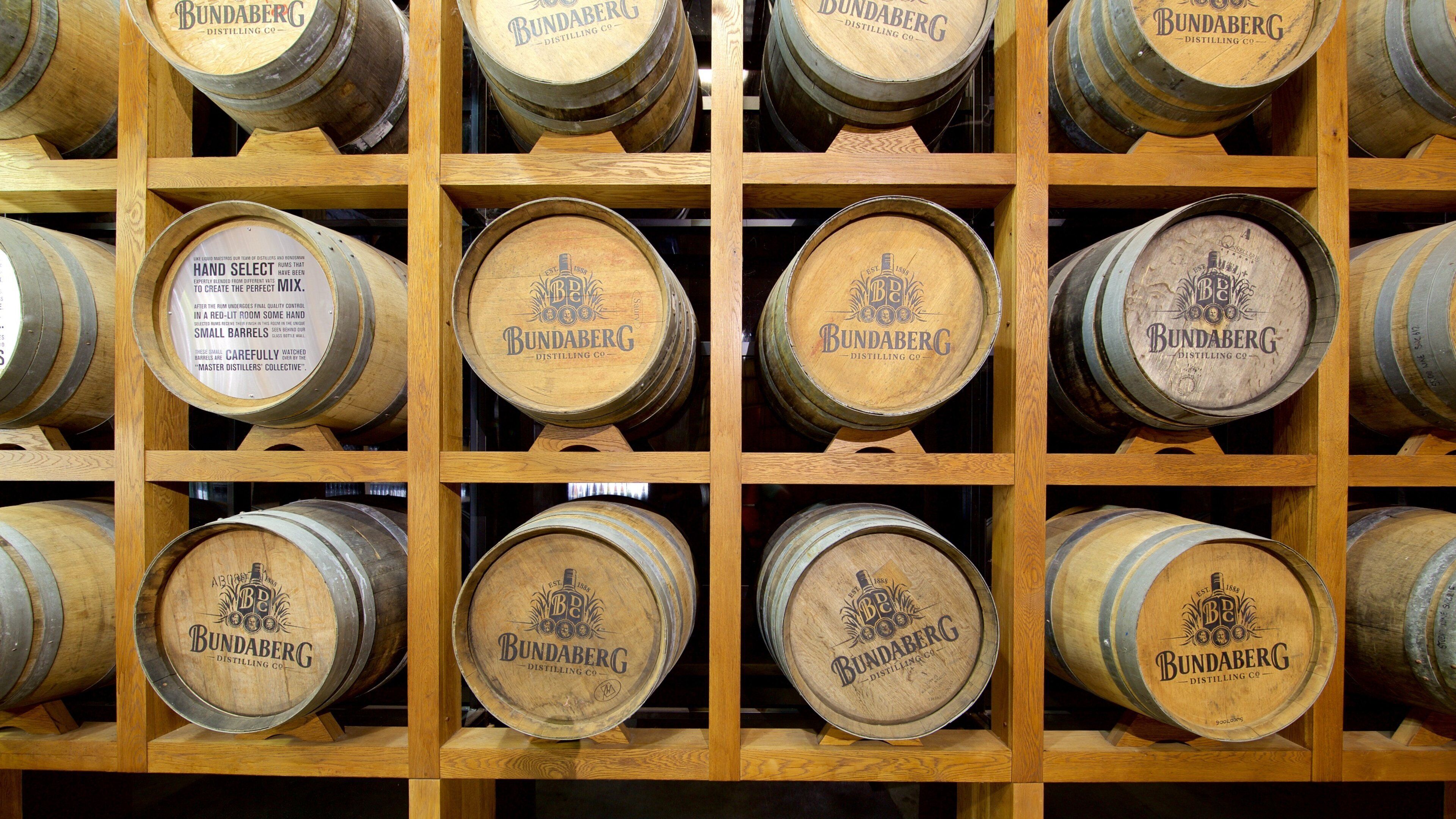 Wooden wine racks holding multiple Bundaberg wine barrels.