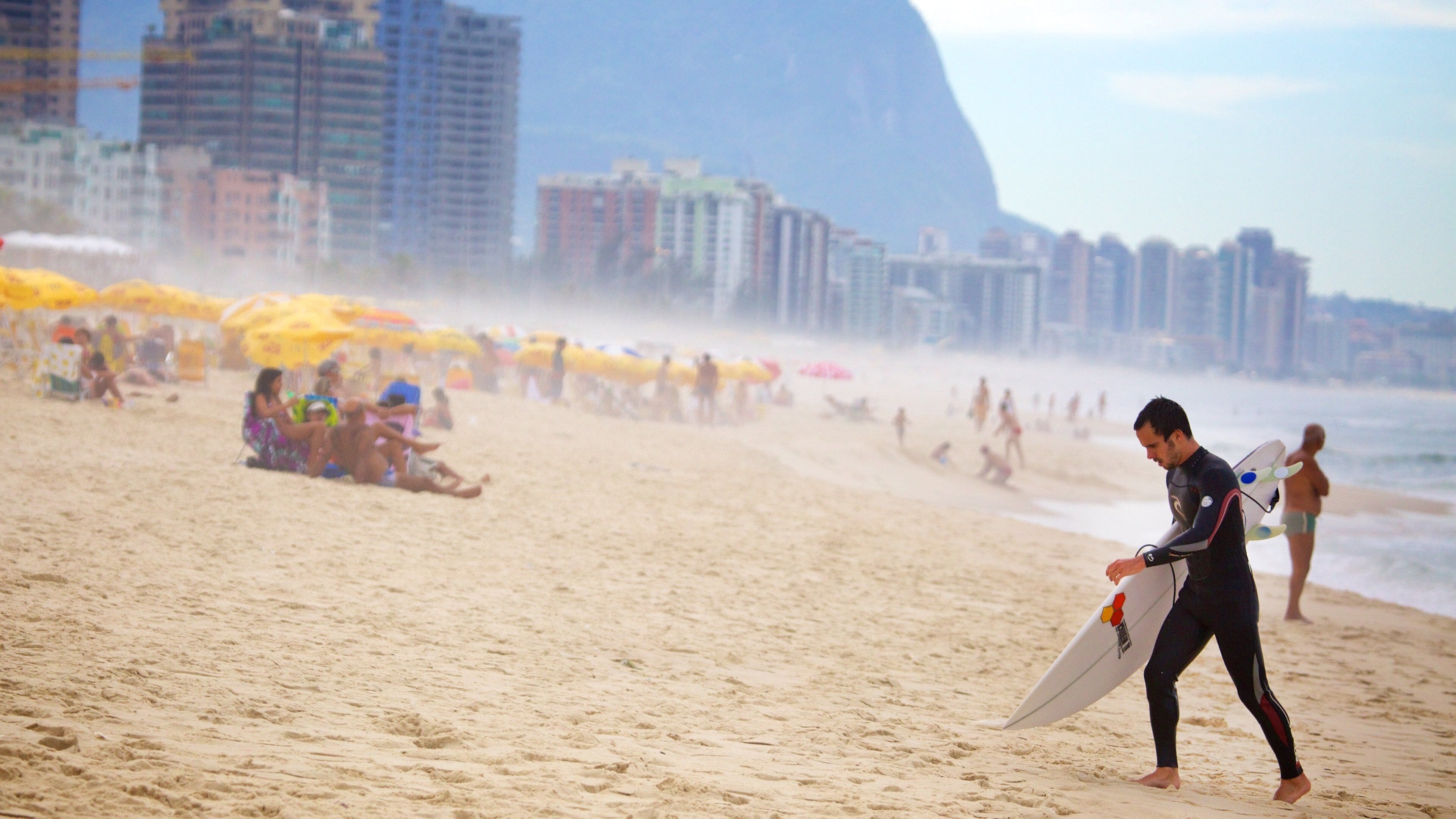 Barra da Tijuca which includes mist or fog and a beach as well as an individual male