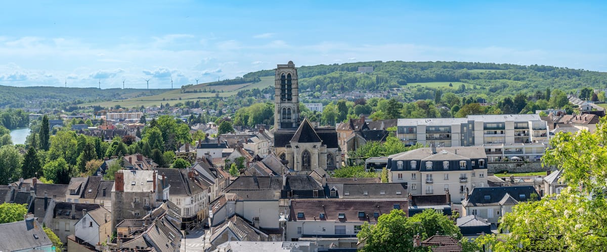Chateau-Thierry, France - 05 01 2026: Panoramic view of the Saint-Crépin Church, the Marne River, the American World War I Monument and the surrounding countryside with sunny blue sky