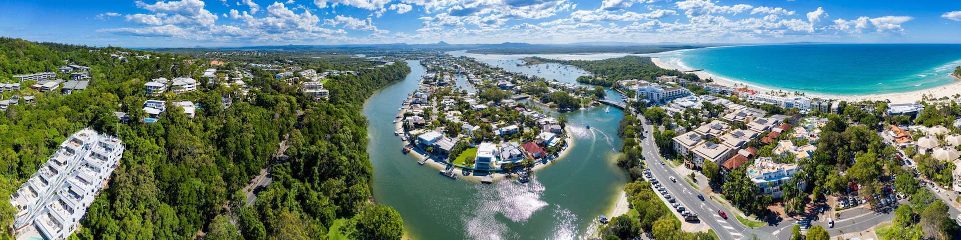 A coastal town with a river, a bridge, and a beach.