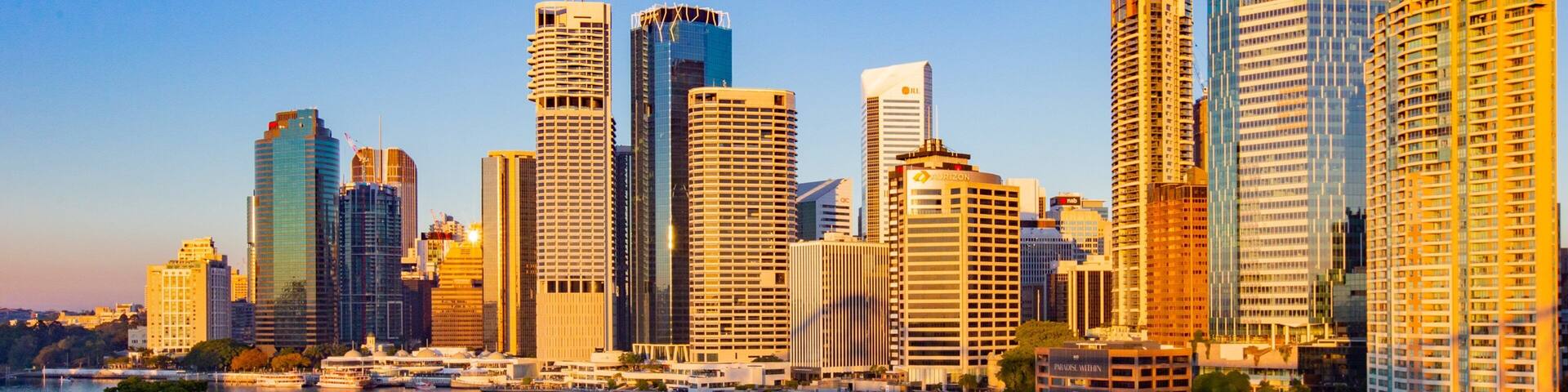 Brisbane Central Business District which includes a river or creek, a sunset and a city