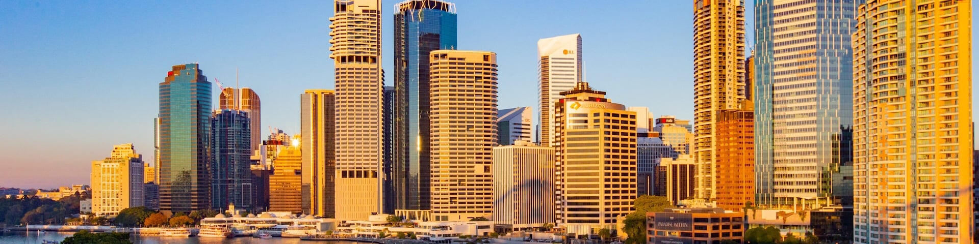 Brisbane Central Business District which includes a river or creek, a sunset and a city