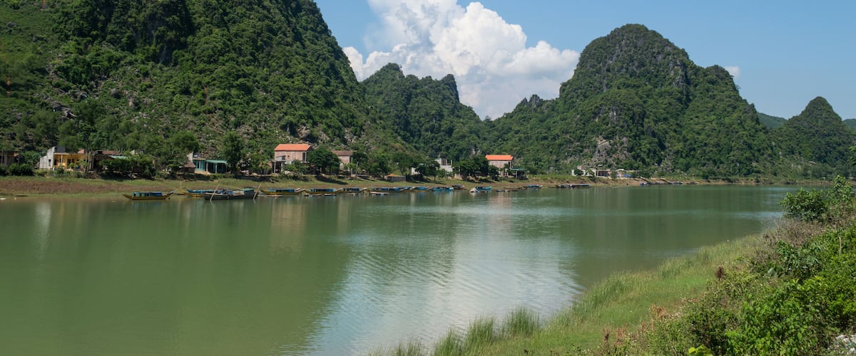 Limestone Landscape with River, Boat and Village, Dong Hoi, Vietnam