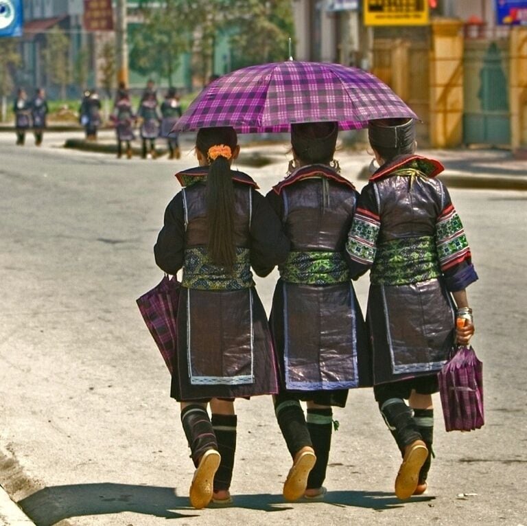 Traditionally clad Black H'mong girls out for a stroll around Sa Pa Lake.