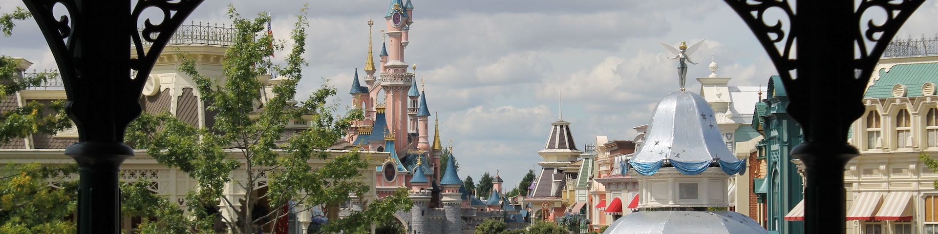 A crowded street with a castle-like building in the background.